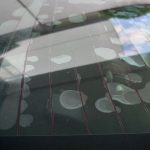 Water droplets beaded on an automotive rear window