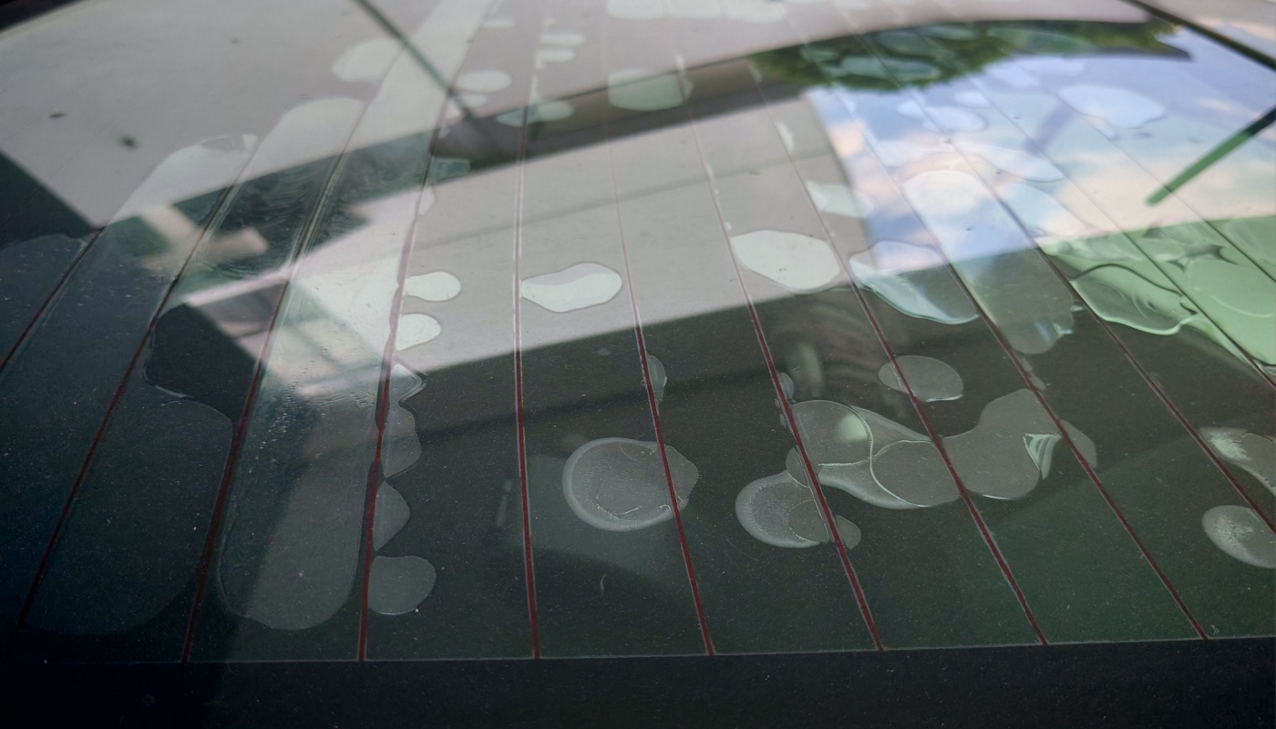 Water droplets beaded on an automotive rear window