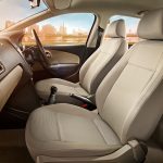 Car interior primarily the front 2 seats, passenger and driver seat behind the steering wheel and dash