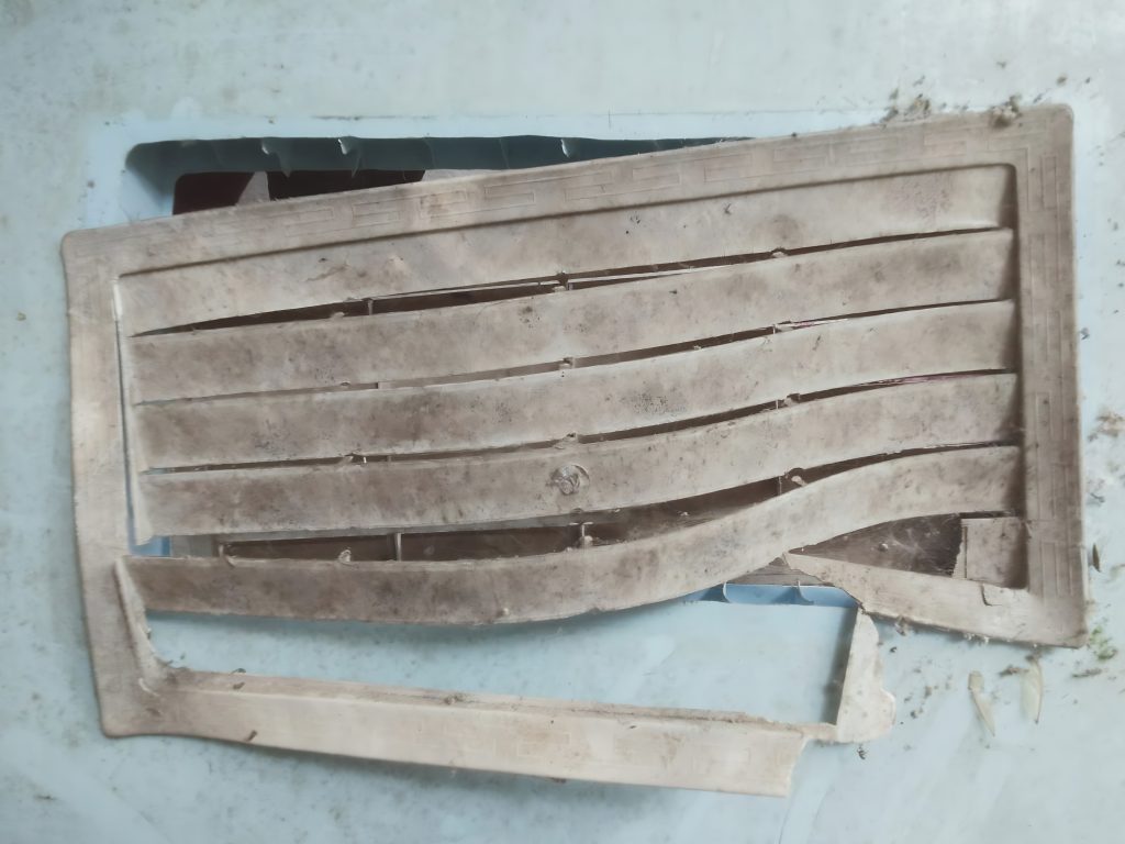 A close up shot of a heat warped plastic ventilation grill