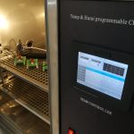 Thermal and humidity test chamber with samples on the shelves.