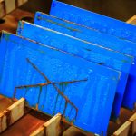 Scribed coated steel test panels after salt spray testing.